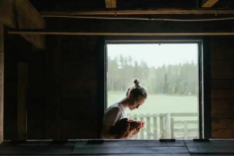 woman holding her chicken