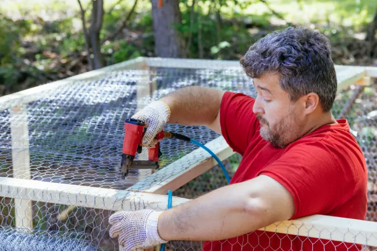 farmer building his chicken coop
