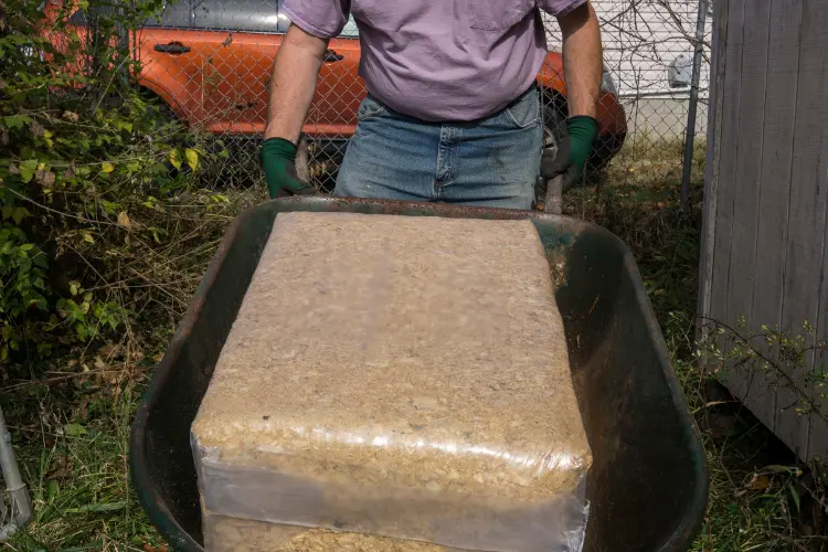 farmer with bale of new beddings