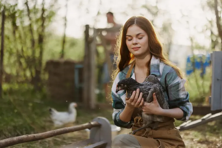 a farmer holding her chicken