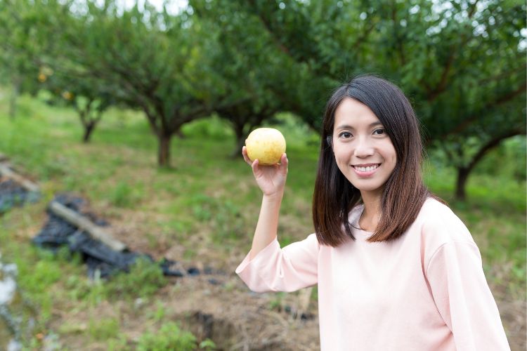 a farmer holding a pear